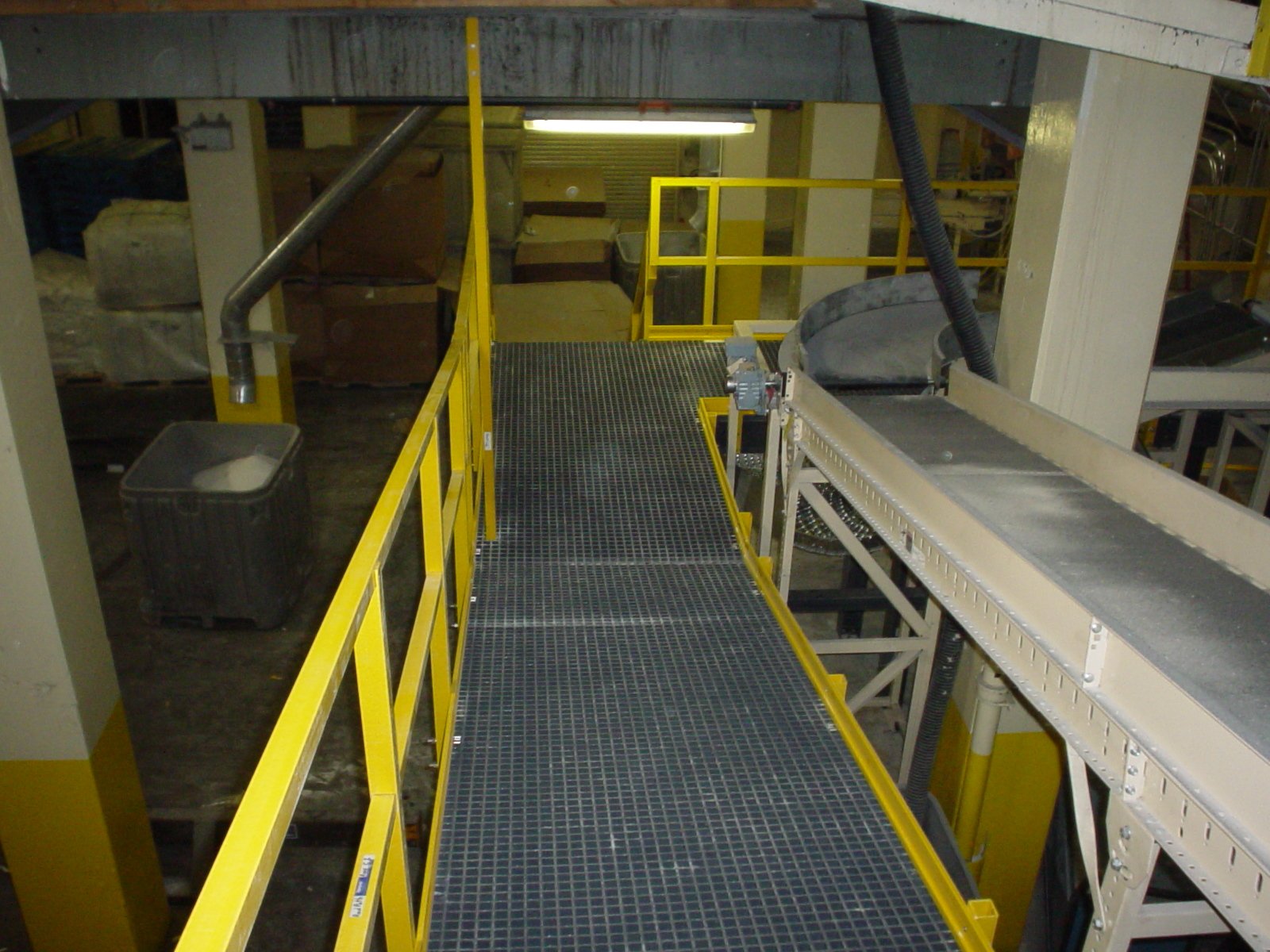Conveyer access platform with FRP grating in a food processing facility