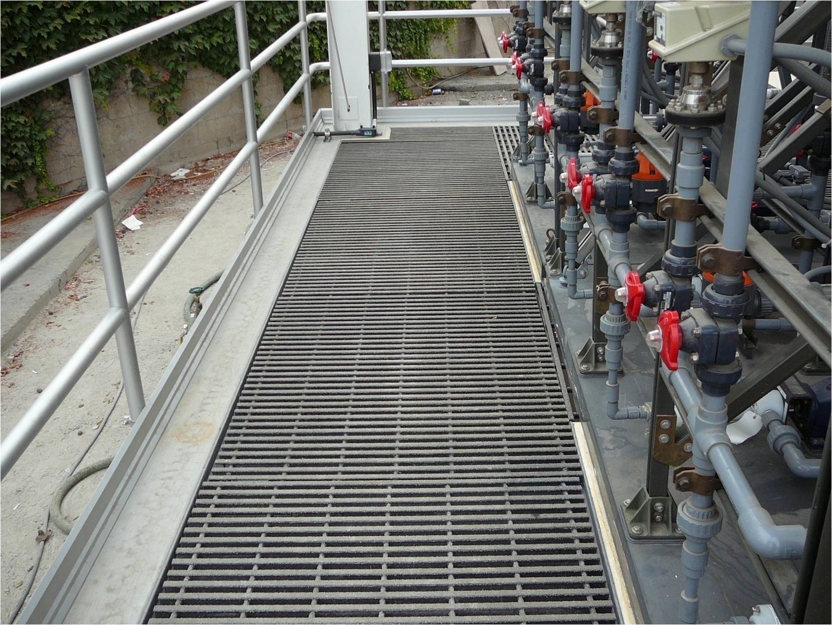 Dark grey pultruded grating at a wastewater plant